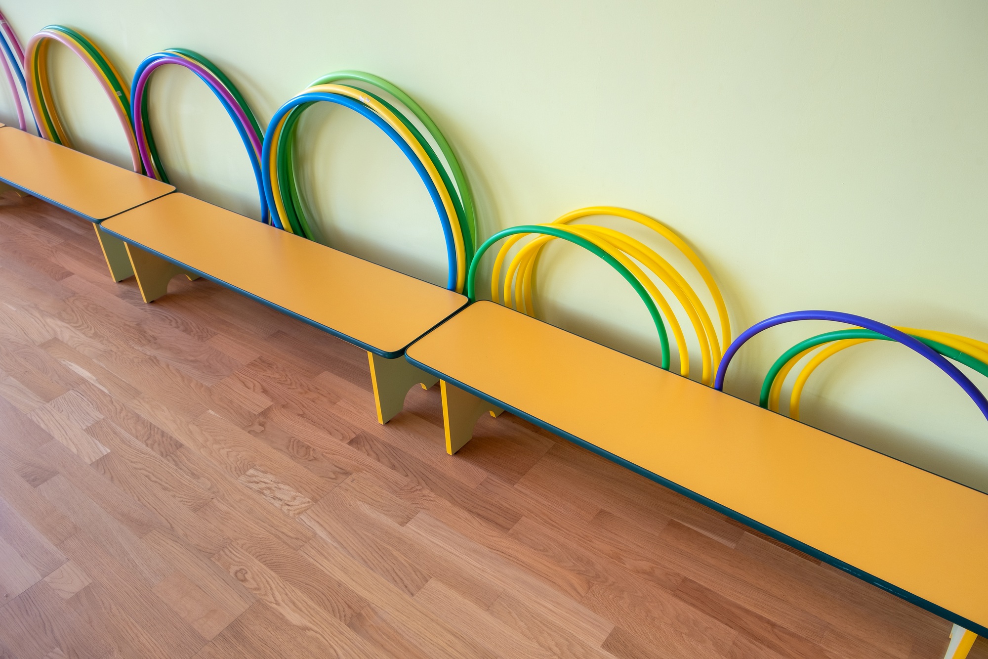 Yellow benches inside a school sports gym.